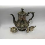 A silver-plated coffee pot with embossed foliate design, together with a silver cream jug,