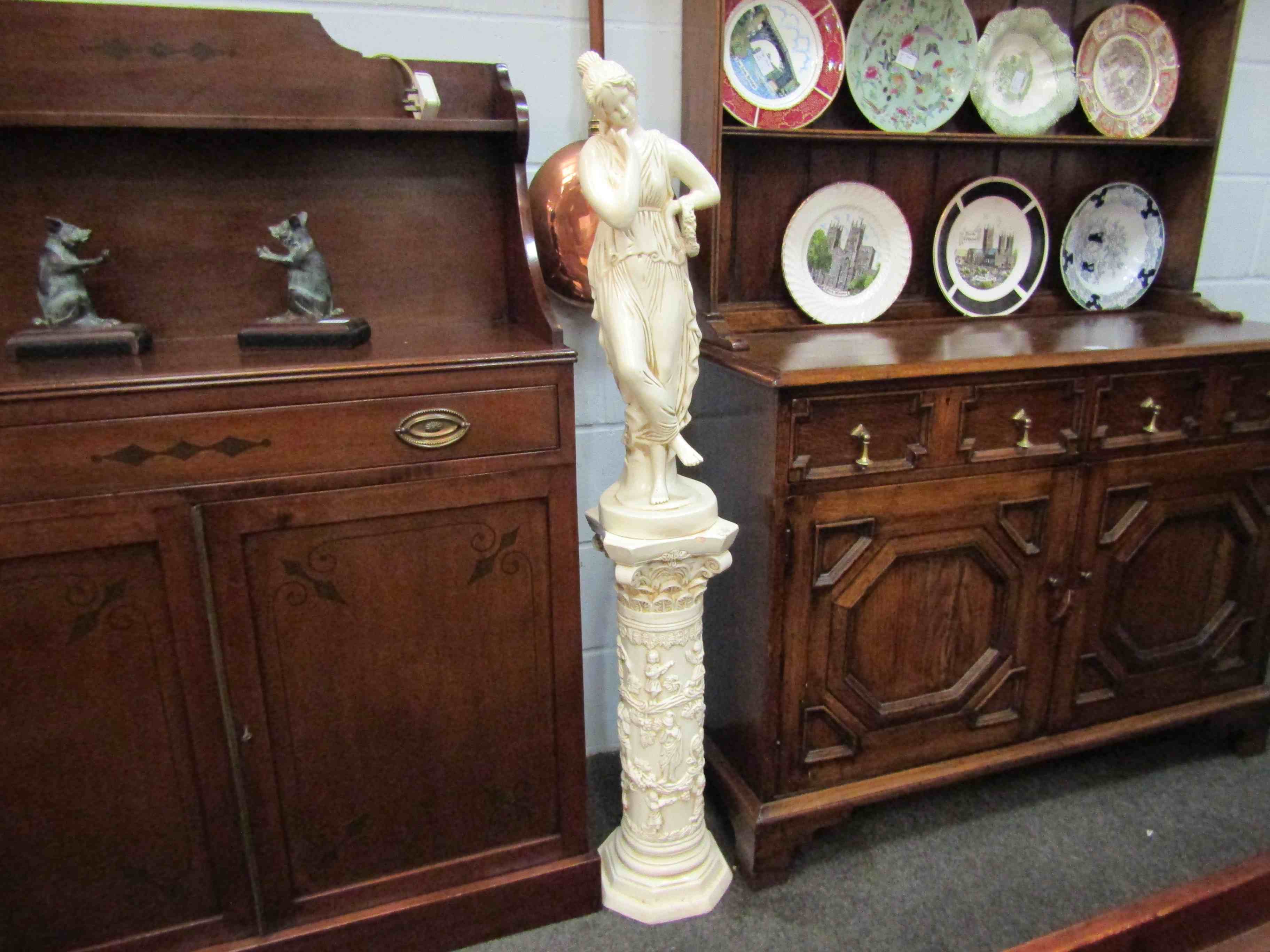 Classical female figure on pedestal,