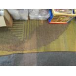 A 1960s woven rug of square form and green ground (a/f),