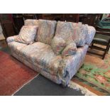 An early 20th Century sofa with feather filled cushions,