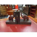 A pair of oak bookends in the form of elephants