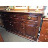 An oak sideboard, three drawers over three cupboards,