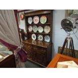 An oak dresser with plate rack back, two drawer on two cupboard door base,