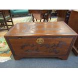 A mid 20th Century Southeast Asia camphor wood trunk with carved decoration and sliding tray (with