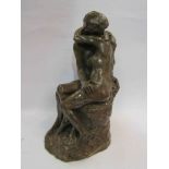 A brown glazed plaster figural group of nude couple embracing,