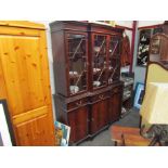 An astragal glazed top over three drawer three door cupboard base bookcase,