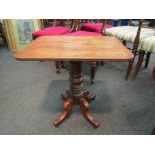 A mahogany lamp table on turned column and quatreform base,