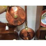 A copper bed warming pan and another