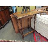 An oak occasional table with barley twist legs,