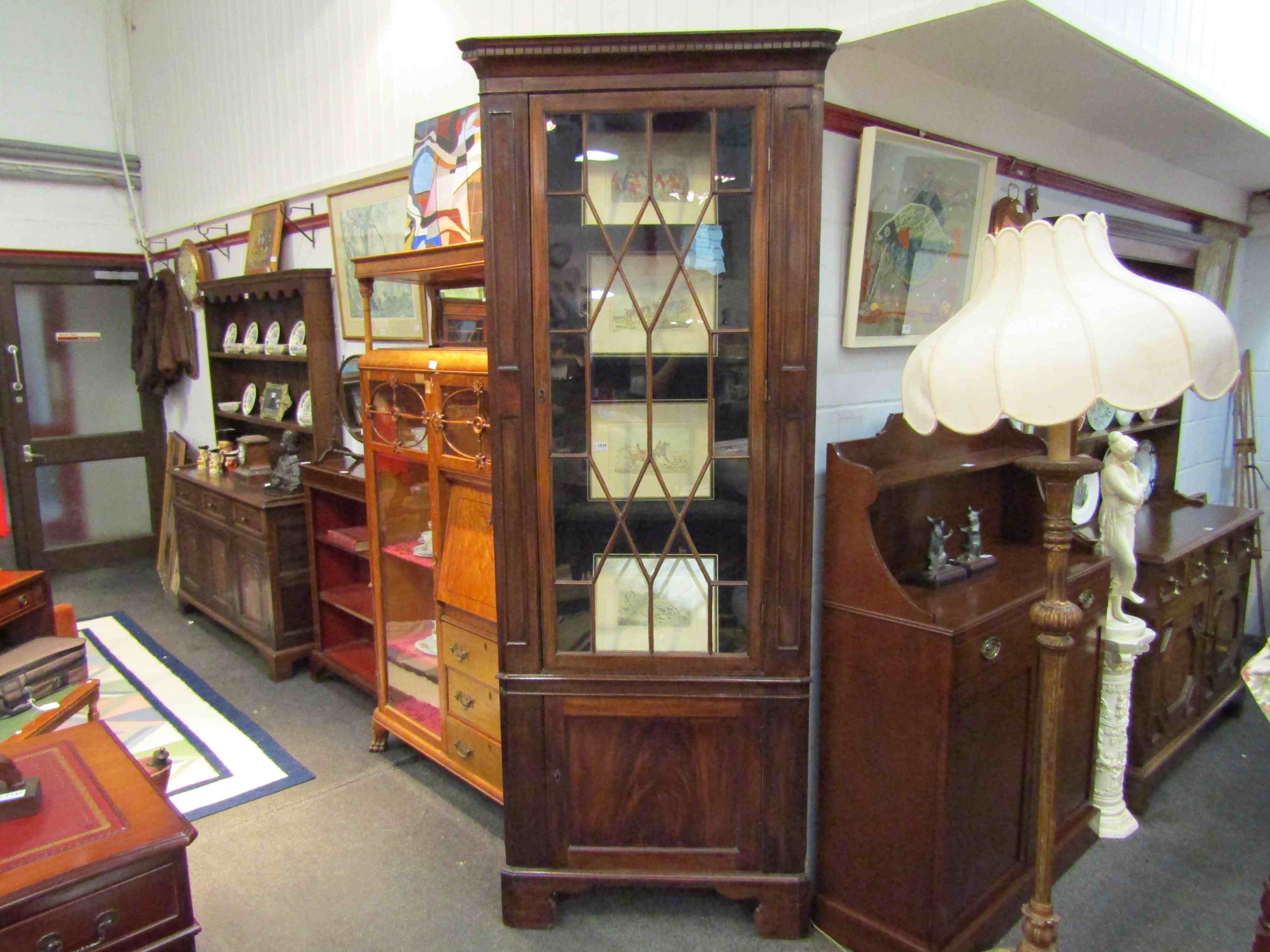 A Georgian mahogany tall corner cupboard with glazed door over cupboard door,