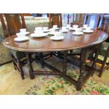 An 18th Century and later oval top drop leaf dining table with single end cutlery drawer over
