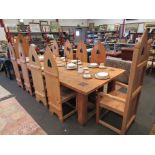 A hand-crafted Gothic style oak refectory dining table with ten (8+2) matching chairs,