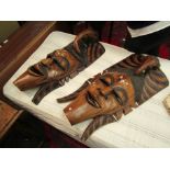 A pair of African Eastern hardwood wall mounting face masks,