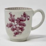 Pink monochrome coffee cup, painted with a flower spray and sprigs.