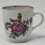 Polychrome coffee cup painted with flower spray and sprigs.