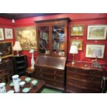 An astragal glazed mahogany cabinet on bureau base, two short over two long drawers.