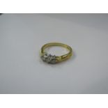 An 18ct gold three stone diamond ring, size U, 4.