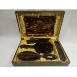 A cased tortoiseshell dressing set,