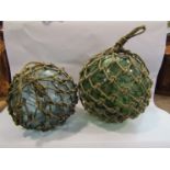 Two 19th Century green glass buoys with net case
