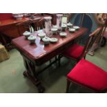 A William IV rosewood library table the two frieze drawers over a lyre end base joined by a turned