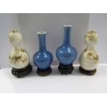 Two pairs of Oriental vases, blue ground and floral design on stands and a similar bowl,