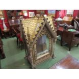 An ecclesiastical gilt tabernacle with arched doors, glazed panels and carry handles,