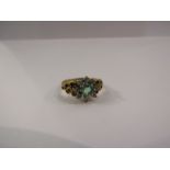 An 18ct emerald and diamond cluster ring
