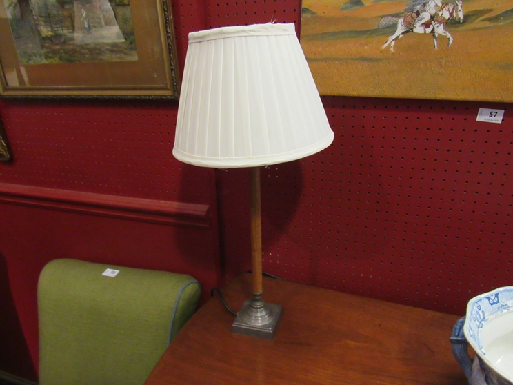 A mahogany and metal table lamp with cream shade