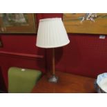 A mahogany and metal table lamp with cream shade