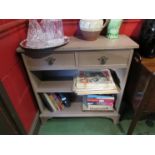 A painted hardwood floor standing open bookcase, with turned front feet,
