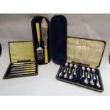 A cased set of silver backed knives,