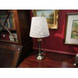 A bronzed metal table lamp with cream shade