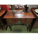 A Georgian oak lowboy with crossbanded fitted drawers on pad feet,