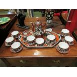 A porcelain coffee service and tray, hand painted Eastern style decoration in black,