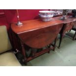 A 1930's mahogany oval-top gateleg table,