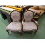 Two floral upholstered chairs on cabriole legs with carved floral detailing
