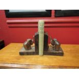 A pair of oak bookends with carved elephant detail,