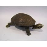 A clockwork cast metal bell in the form of a tortoise
