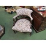 A mahogany open armchair on cabriole legs in William Morris style upholstery