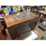 A Japanese camphor wood chest with lid carved with pagoda and figural scenes,