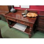A mahogany two drawer side table with gallery back and undertier,