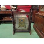 A mahogany fire screen with lead and glass floral panel, turned spindles,