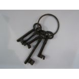 A set of five cast iron reproduction keys on ring