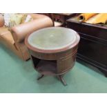 A reproduction drum table with insert tooled leather top,
