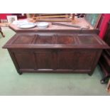 An 18th Century oak four panel hall coffer the hinged lid over turned stile feet,