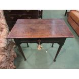 An 18th Century oak side table with plank top, frieze drawer,