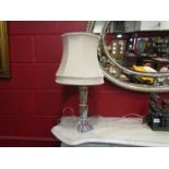 A pair of cut glass table lamps with cream shades,