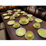 A quantity of yellow ground Shelley china teacups and saucers,