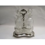 A Victorian silver plated Tantalus with three cut glass decanters