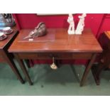 A George III mahogany folding tea table with small frieze, on rectangular section legs,